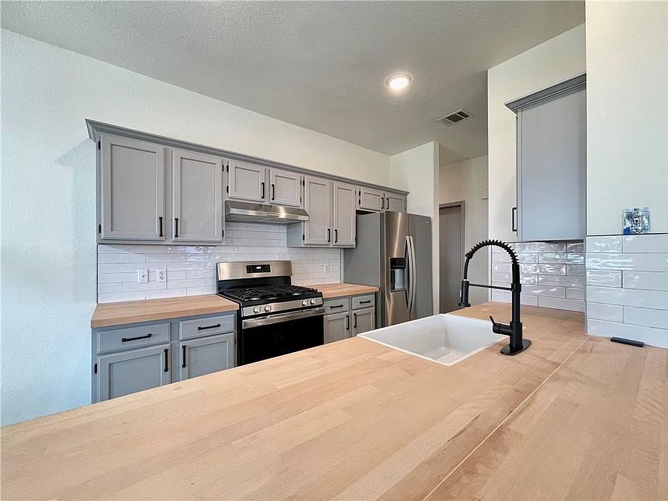 Remodeled kitchen with butcher block countertops and stainless steel appliances! A chef's dream!