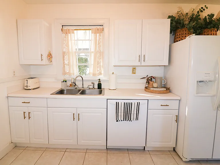 Kitchen features ample cabinet space, fully stocked with plates, bowls, utensils, cookware and more