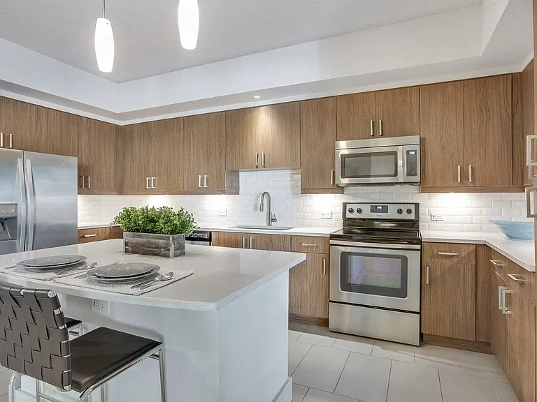 Our chef-inspired kitchens feature stainless steel appliances and quartz counter tops