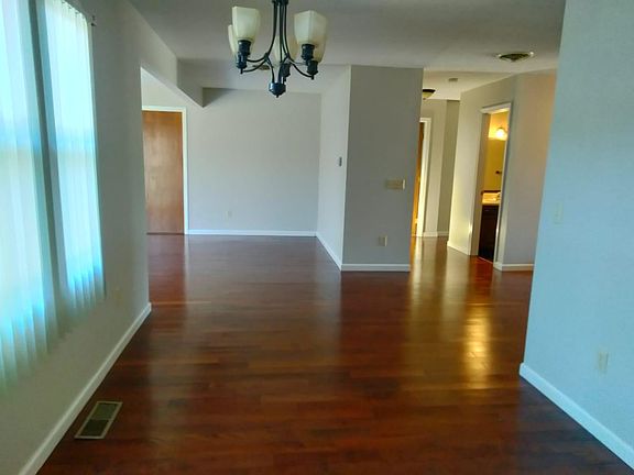 Dining / Living Area Office entryway on the left. Bedrooms and Bathrooms on the right. Hard right is garage entry and front door entry.