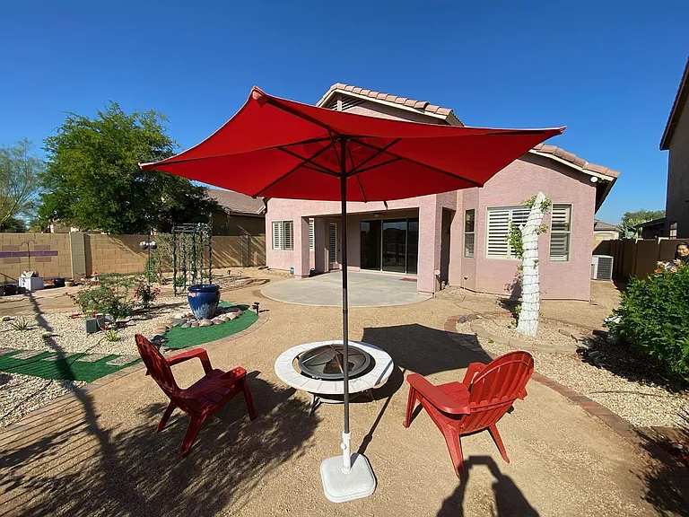 Beautifully landscaped backyard oasis featuring stunning Estrella Mountain and South Mountain views. Unwind and enjoy the backyard with family and friends! Picture taken November 17, 2023 early afternoon.