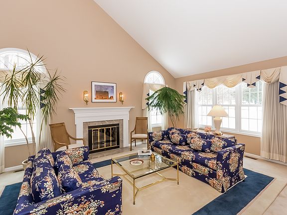 Inviting Step-Down Living Room with Palladian Windows