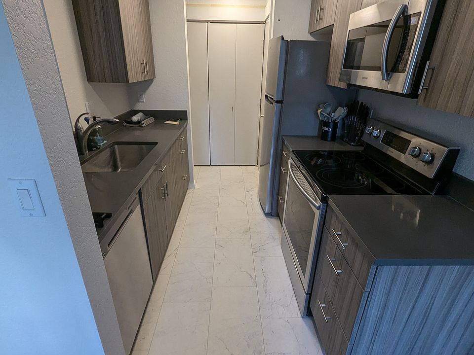 Kitchen off dining with quartz countertops and stainless appliances. Soft close drawers, quiet dishwasher.