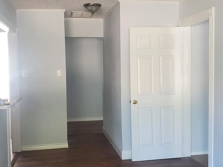 living room looking down hallway to an extra bedroom and master bedroom