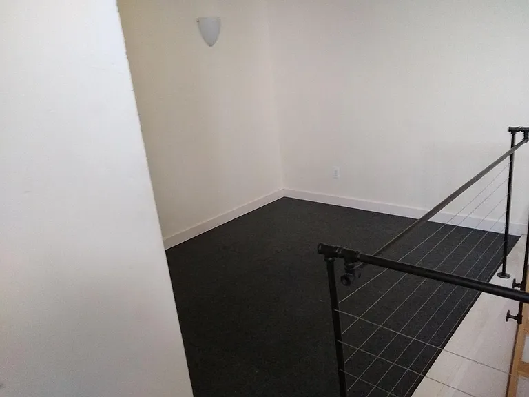 Loft/bonus space overlooking living area is very flexible.
