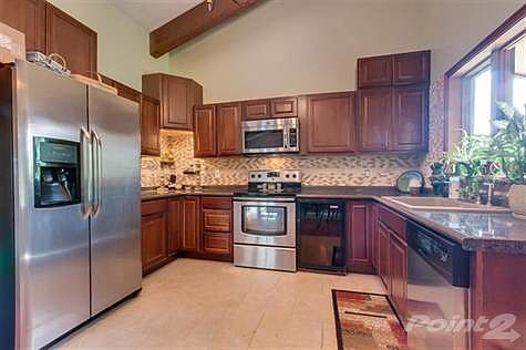 Simply Gorgeous! Wood cabinets, SS Appliances, Beam Ceilings, Large windows