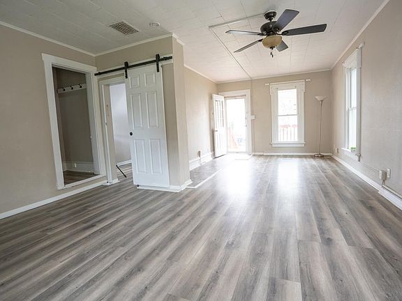 Dining Room with view of Family Room, Doorway to Upstairs, Door to Den/Bedroom, and Front Door