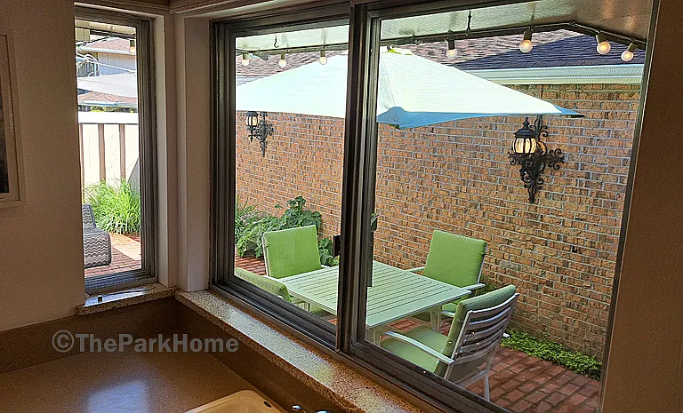 The window over the kitchen sink looks out onto your private patio.