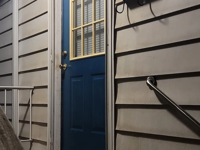 Front door, left side of house if facing from 6th Street.