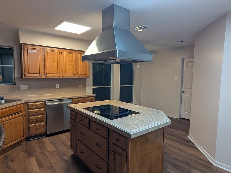 A professional quality Vent-a-Hood is perched over a brand new high-powered LG ThinQ-ready induction cooktop. This high-end cooktop will boil a pot of water in 90 seconds or simmer low enough to soften butter to perfection.
