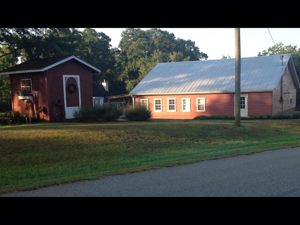 View from street. Barn & pump house.