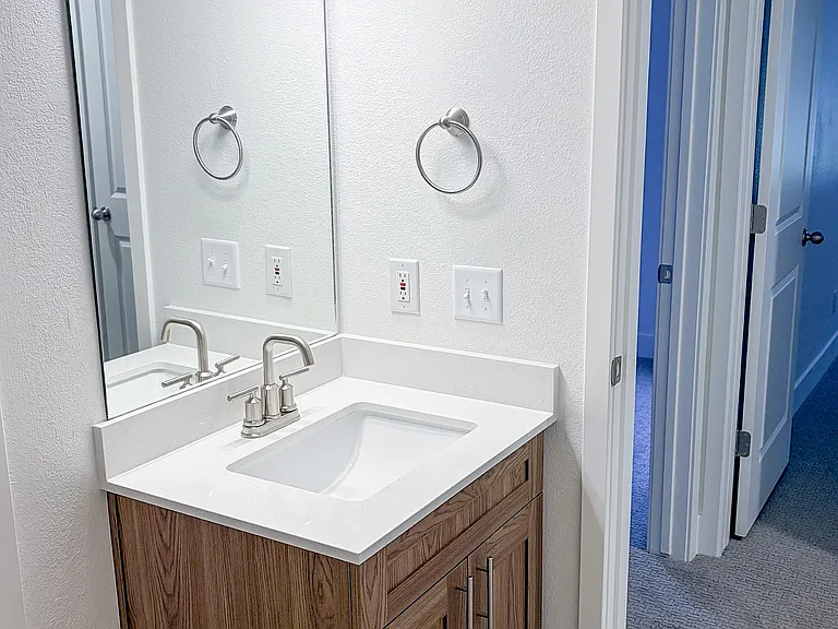 Modern bathroom finishes combine style and practicality with updated cabinetry and lighting.