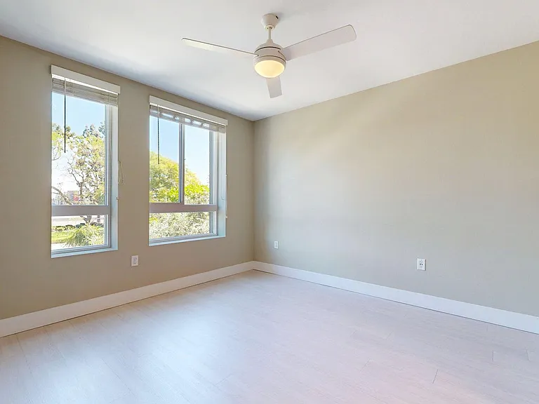 Spacious apartment Bedroom with Wood-Style Flooring.