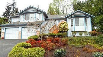 Bay windows and brick accents add to the curb appeal of this home