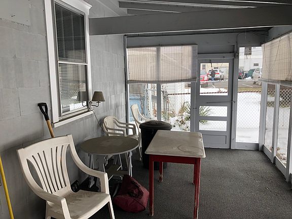 Side door leads to alley and trash bins.