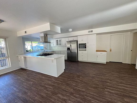 Dedicated pantry and microwave area provides additional storage capacity in the updated kitchen designed for functionality.