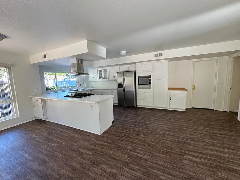 Dedicated pantry and microwave area provides additional storage capacity in the updated kitchen designed for functionality.