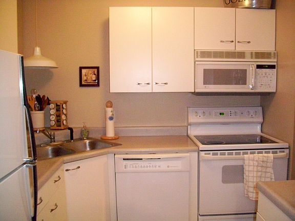 Kitchen has smooth top range and built in microwave.
