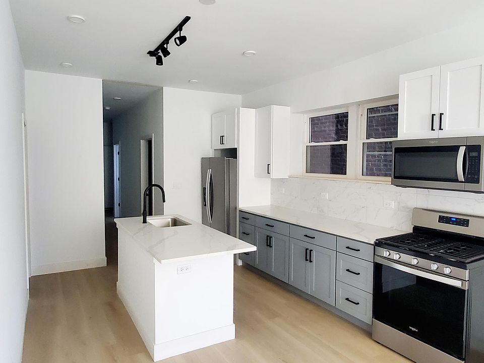 Kitchen with brand new stainless steel appliances and quartz counters