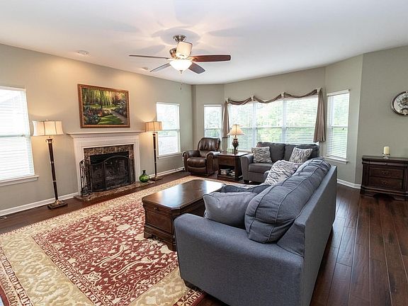 Great Room with newer Engineered Hardwood floors and W/B fireplace