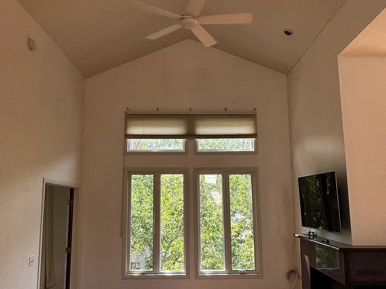 Living room has gas fireplace, cathedral ceiling.