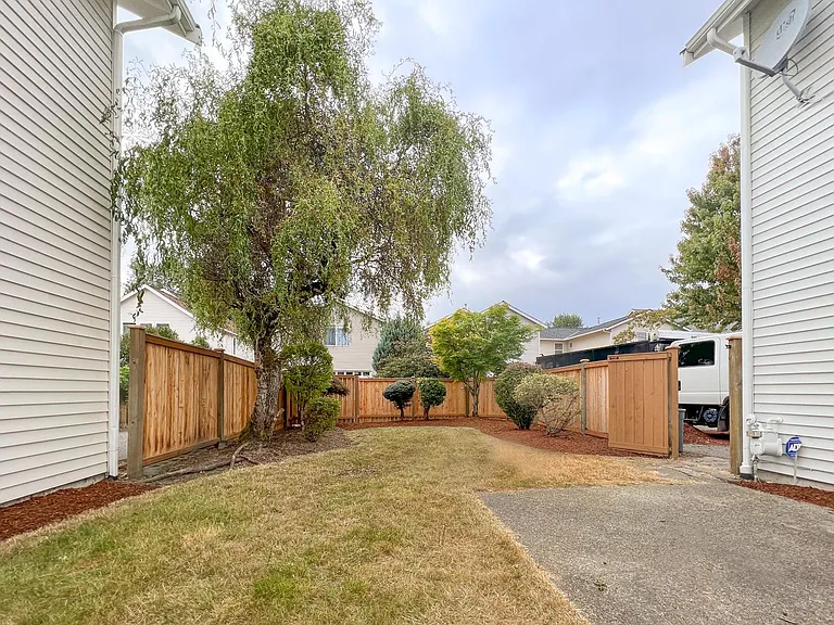 Spacious backyard with beautiful tree that provides shade in the summer. Enough backyard for a trampoline, baseball nets or relax with a hammock or grill.
