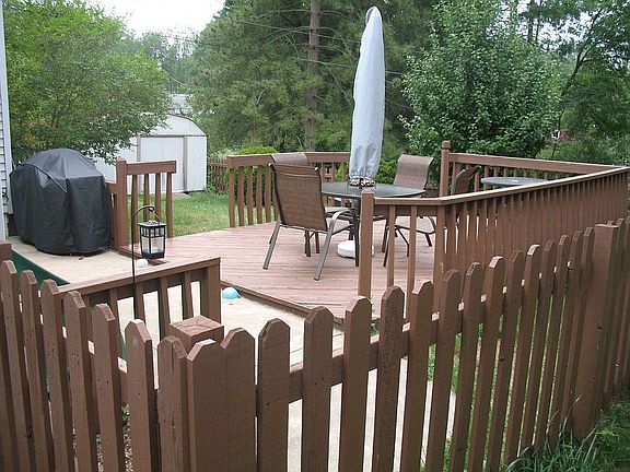 two tier deck in fenced backyard