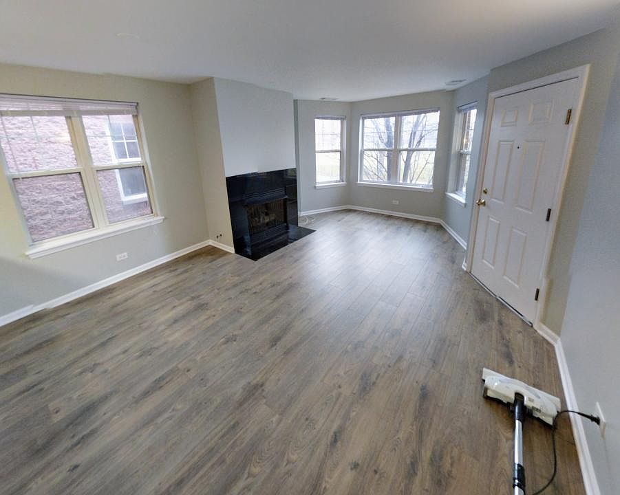 Living Room, new hard floors, with Gas Fireplace facing Divi