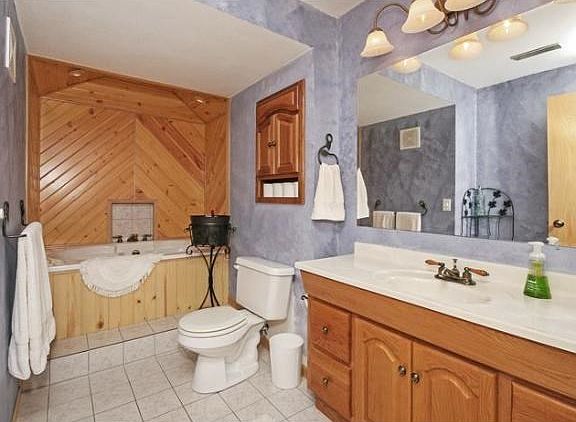 The lower level bathroom offers knotty pine and giant Jacuzzi tub!