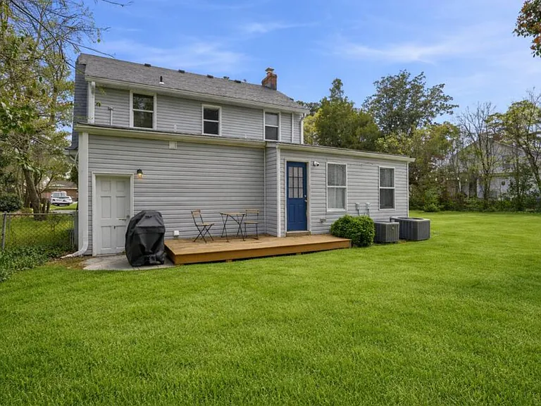 The huge backyard includes a deck and grill. Perfect for kids or pets that want to run around.