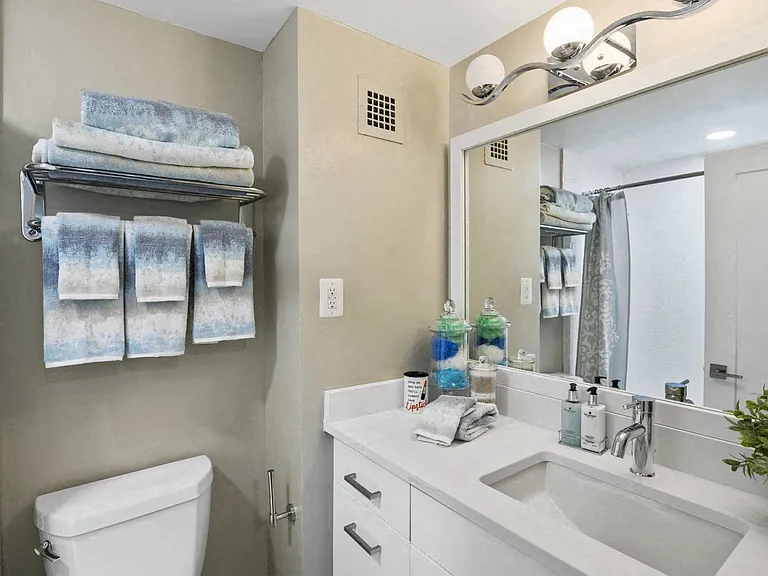 Sleek Bathroom Finishes Including Quartz Countertops and Oversized Vanities