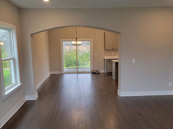 arched doorway from family room into eat in kitchen out to back patio!