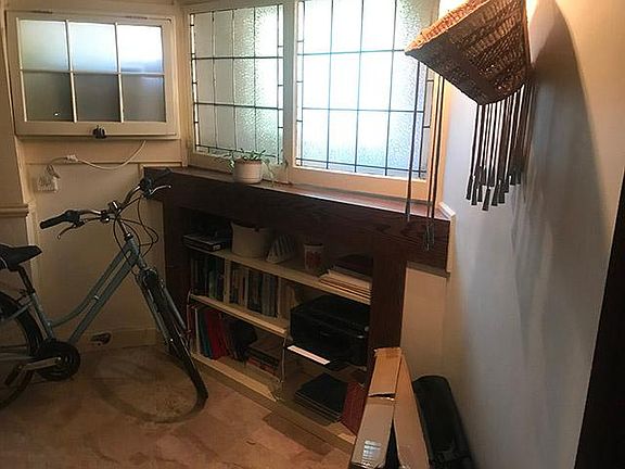 Front of apartment. Lead glass windows swing open if desired. Built in bookcase.
