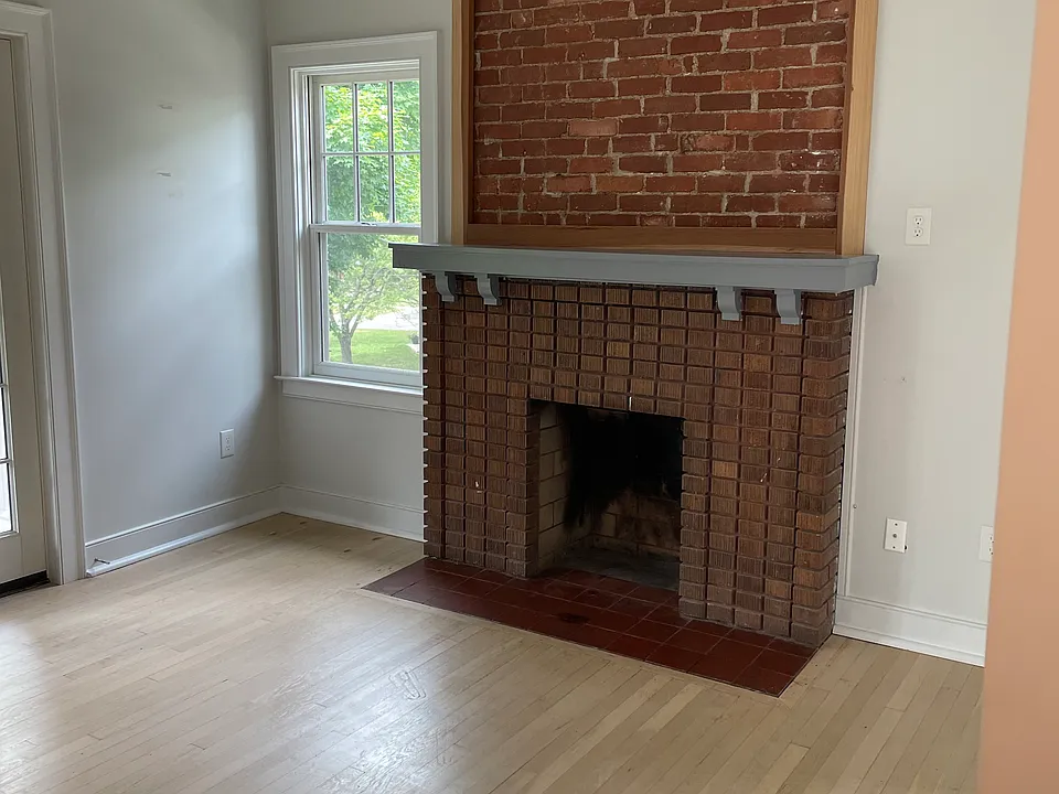 Original fireplace. Can't be used but wonderful for ambiance. That sliver of a door that you can see on the far left of this pic leads into the second "bedroom".
