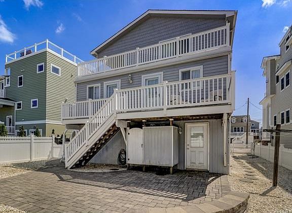 Rear of home with paver patio, plenty of deck space