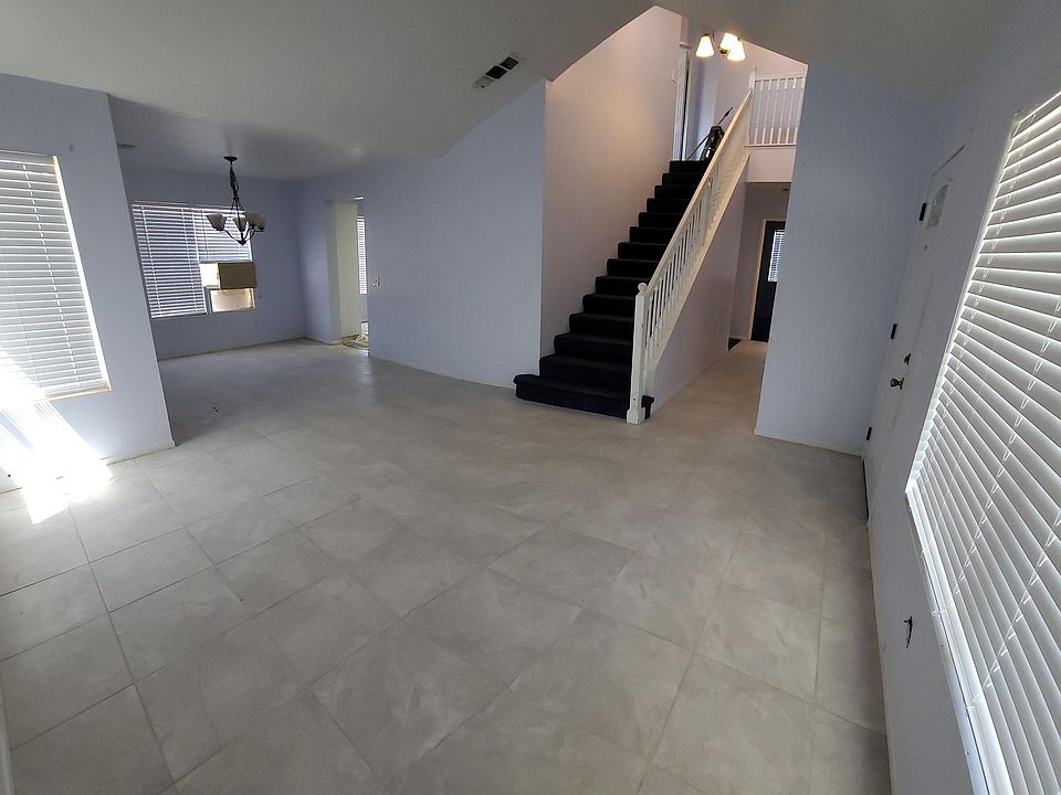 Living Room, Entery To Kitchen and Hallway Leading to Eastside Bed Room and Family Room (Panoramic Shot)