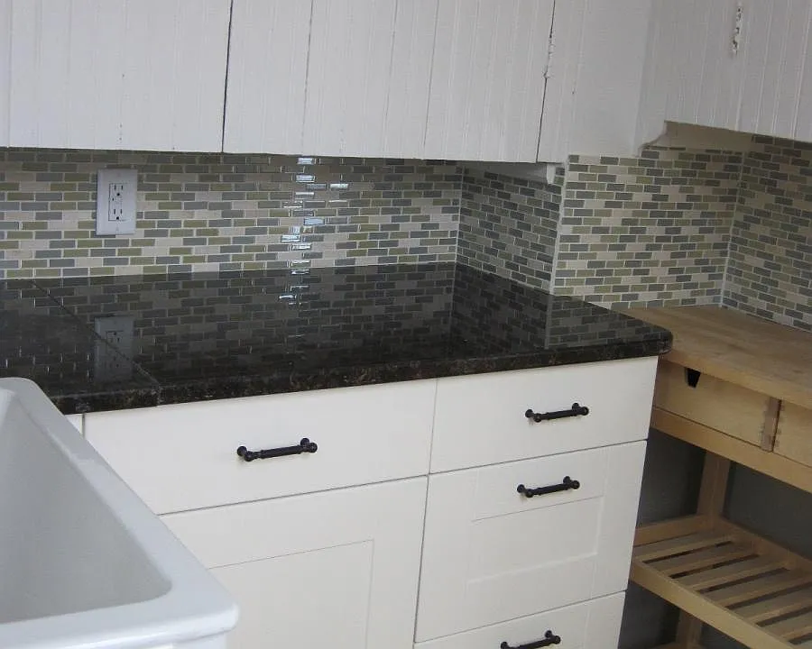 pantry with view of granite countertops, tile backsplash and