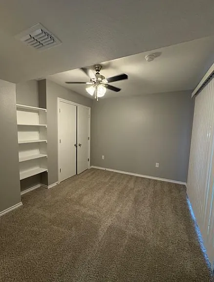 Spacious bedroom with large windows and natural lighting