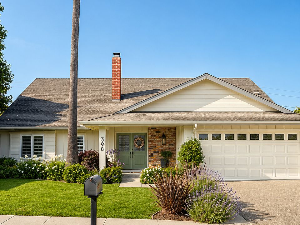 Front of the house with a beautiful skinny palm tree