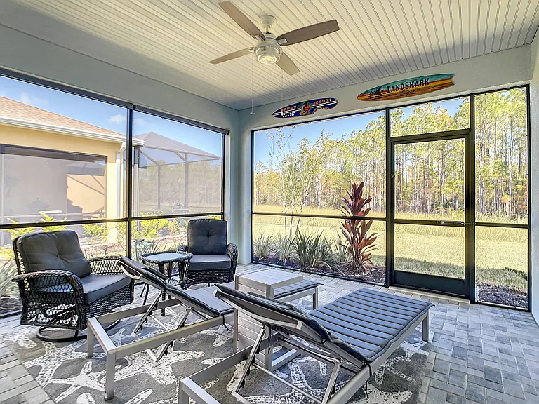 Screened-in Lanai with view of wooded preserve