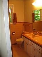 original tile with updated toilet and faucets