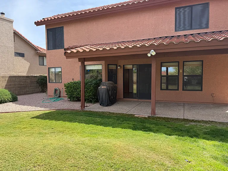 Grass backyard with included monthly landscaper