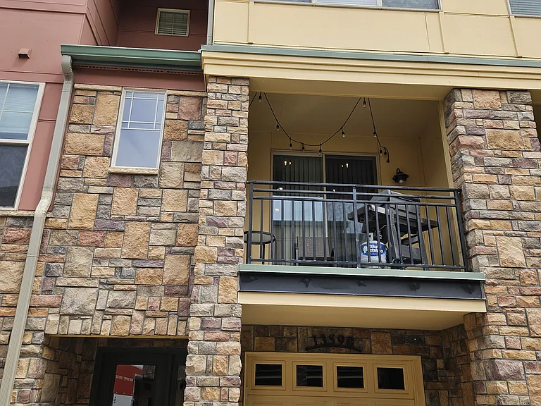 The townhouse from the outside - the patio continues behind the stone wall with the small window