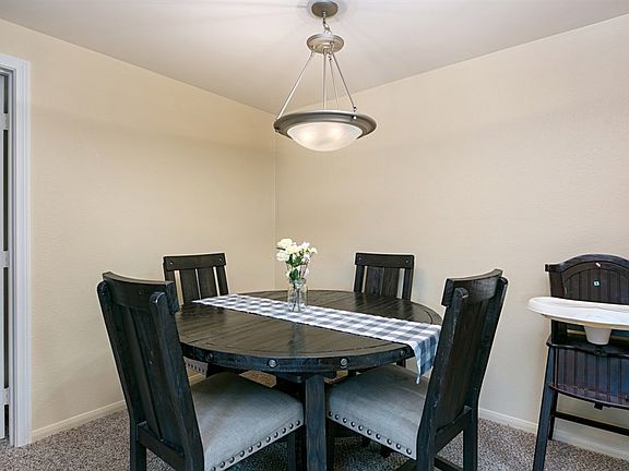 The dining room shows off the home's fresh paint and new carpet!