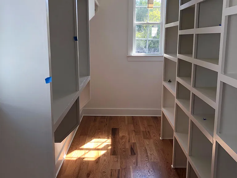 Huge walk in master closet with custom shelving and natural light.