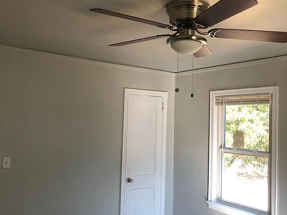 Master bedroom with new ceiling fan and freshly painted. Overlooking private back yard!