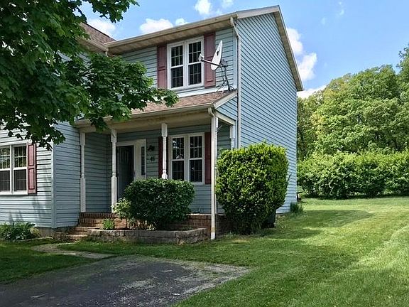 Exterior of home with side yard and driveway