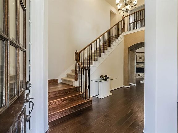 As you enter the front door you are greeted by this beautiful open staircase.