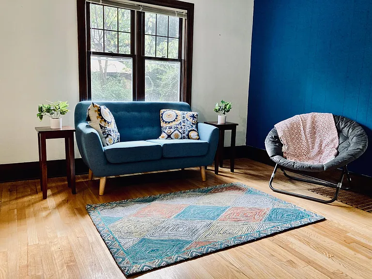 A view of the family room and seating areas. The couch faces the media center.