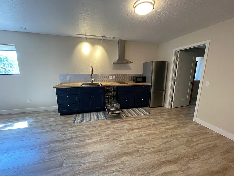 Kitchen. Bedroom door open.